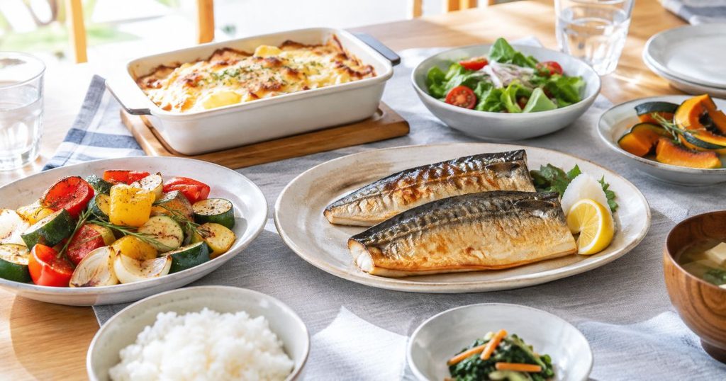 焼き魚や焼き野菜などオーブン調理した料理を並べた食卓